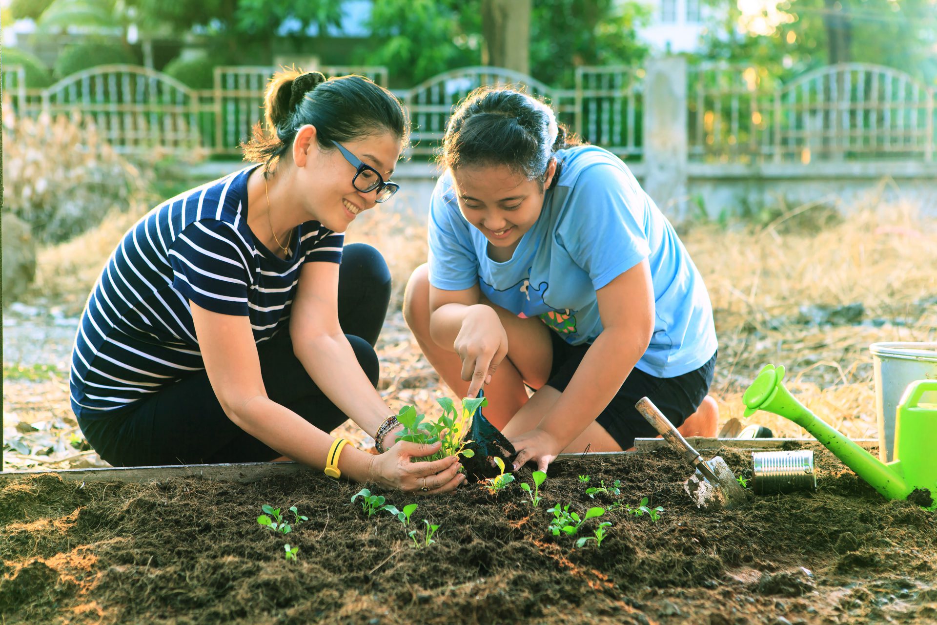Mother and daughter planting garden